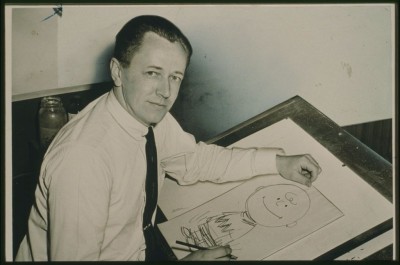 Charles Schulz sits at his drawing table drawing Charlie Brown in 1959, six years before the first airing of "A Charlie Brown Christmas."