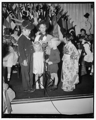 Two American children and children of foreign diplomats participate in an international children's program in Washington, D.C. in 1938.