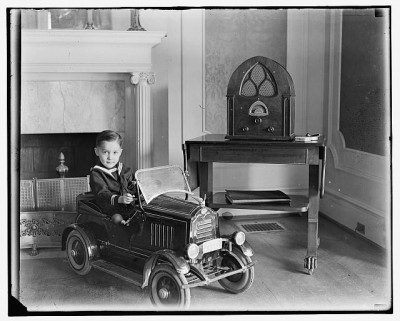 Child in a toy car in the early 1900s, courtesy Library of Congress