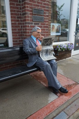 A businessman reads USA Today in "Confirming Predictions."