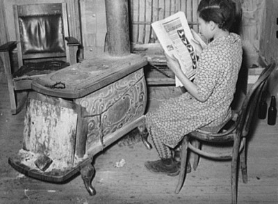 An girl from Oklahoma, who raises chickens for her 4-H project, reads about chickens in a farm magazine, February 1940. Courtesy Library of Congress.