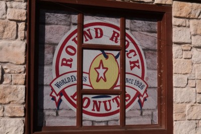 The Round Rock logo is a doughnut with longhorn horns sticking out the top and a Texas star for a hole.