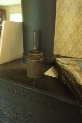 A Blacking Brush and a Sample of Horsehair on an Iron Stove in the Parlor