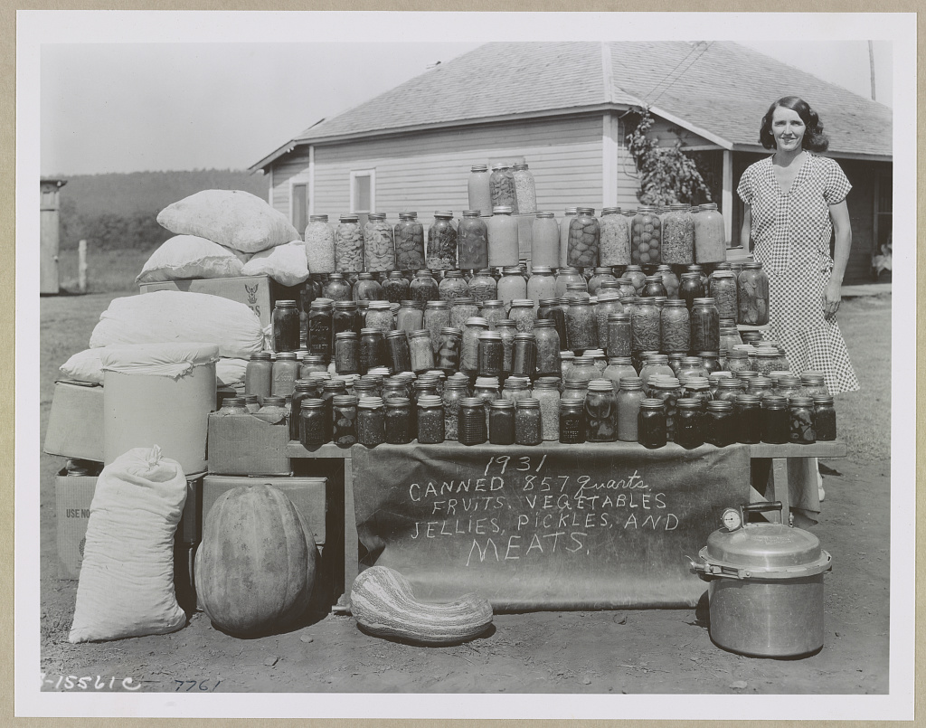 Woman displaying jars of canned food